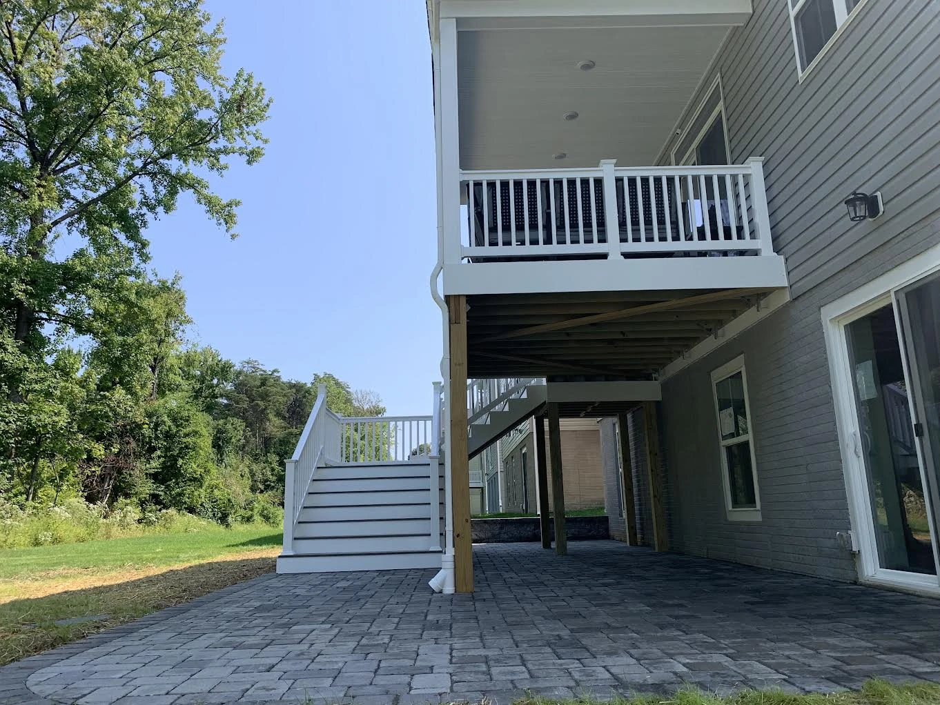 Paver patio beneath a covered deck